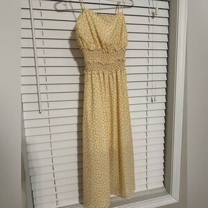 Shin length dress, yellow with white flowers, cinched on the top, ruffles